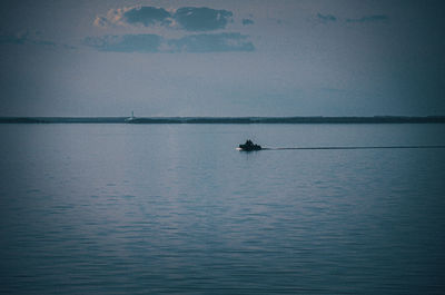 Person on sea against sky