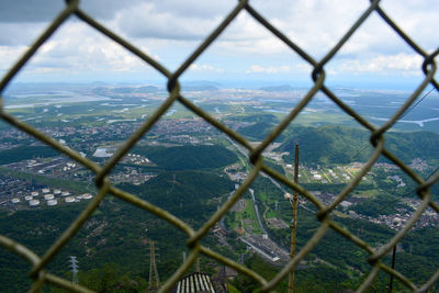 Scenic view of landscape seen through chainlink fence