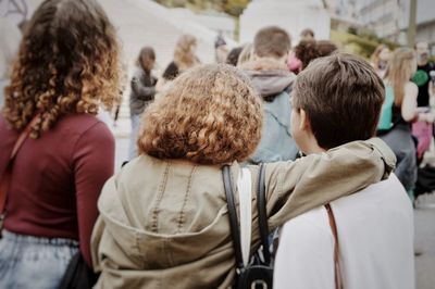 Rear view of people on street in city