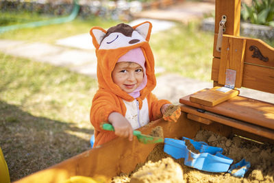 Cute baby playing with shovel at park