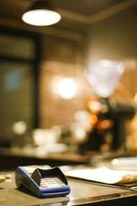 Close-up of mobile phone in cafe