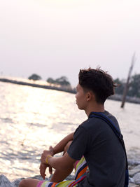 Man looking at sea against sky