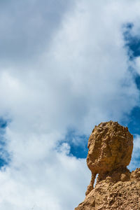 Low angle view of rock formation against sky