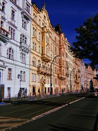 City street by buildings against sky