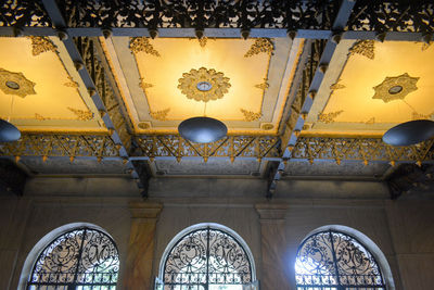 Low angle view of illuminated ceiling in historic building