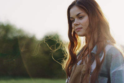 Thoughtful woman standing outdoors