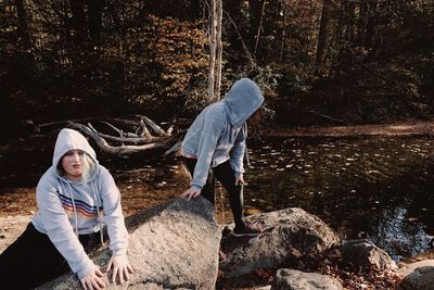 Men standing on rock in forest