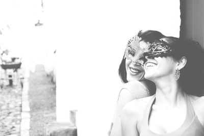 Portrait of two women wearing venice carnival mask. 