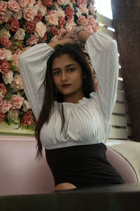 Portrait of young woman sitting outdoors