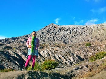 Man standing on rock against mountain
