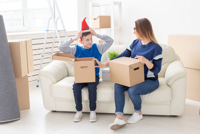 Young couple kissing in box at home