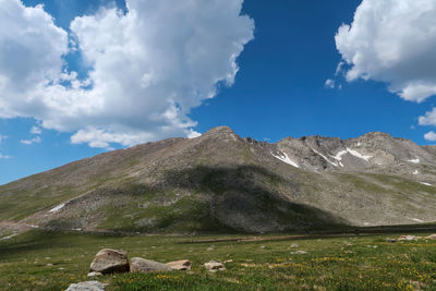 Alpine landscape of meadow and mountain top with clouds at mount evans in colorado