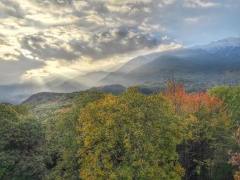 Scenic view of mountains against cloudy sky