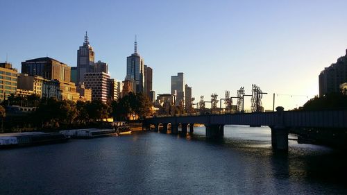 Bridge over river against buildings