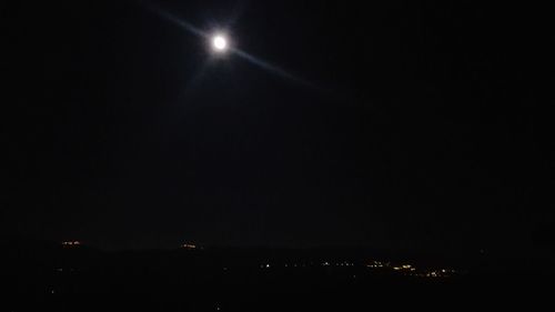 Illuminated lights against sky at night