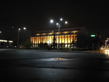 Illuminated city street at night