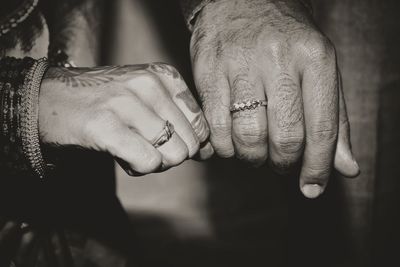 Midsection of couple at wedding ceremony