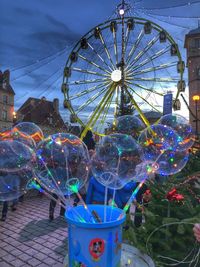 Illuminated ferris wheel in amusement park