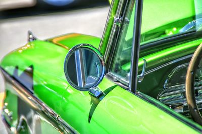 Side-view mirror of green vintage car