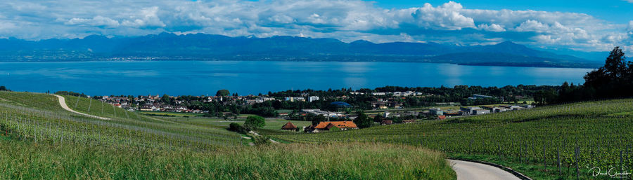 Panoramic view of town by sea against sky