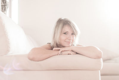 Portrait of smiling woman sitting at home