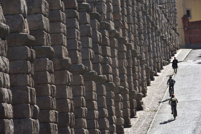 Cobblestone street by building in city