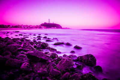 Scenic view of sea against clear sky at sunset