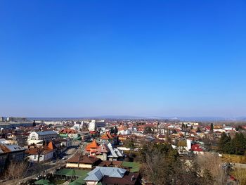 High angle view of cityscape against clear blue sky