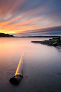 Water pipeline in idyllic sea with dramatic sky