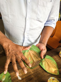 Midsection of man holding ice cream