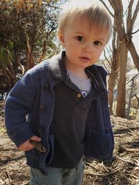 Portrait of cute boy standing on land