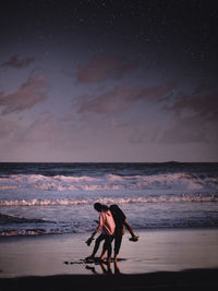 Man at beach against sky
