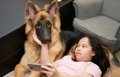 Rear view of woman with dog looking at camera