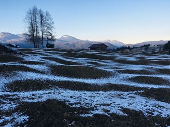 Scenic view of snowcapped mountains against clear sky