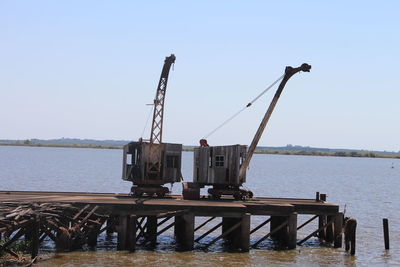 Pier over sea against clear sky