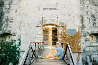 Low section of woman sitting on staircase