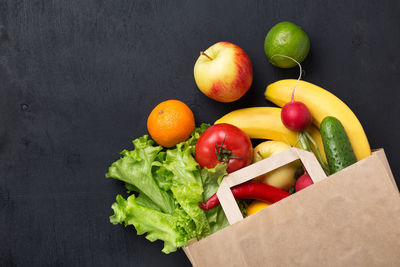 High angle view of fruits on table against black background