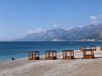 Scenic view of sea and mountains against sky