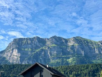 Houses on mountain against sky