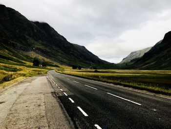 Wide angle photo of the street through glen coe in the scottish highlands