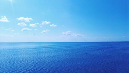 Scenic view of sea against blue sky