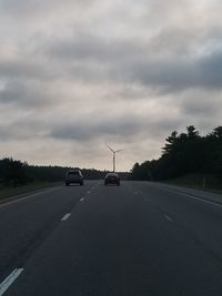 Cars on road against sky