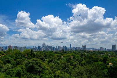 View of cityscape against cloudy sky