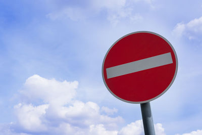 Low angle view of road sign against sky