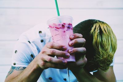 Close-up of man holding milkshake