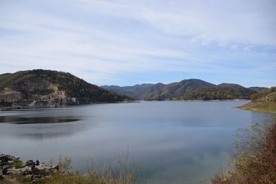 Scenic view of lake and mountains against sky