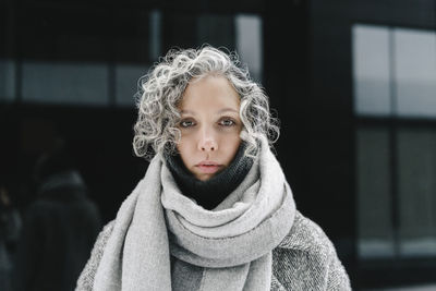 Woman with black expression wearing scarf