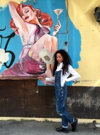 Portrait of young woman standing on ground