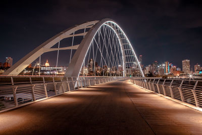 Illuminated bridge against sky at night