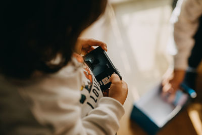 Child playing with digital camera